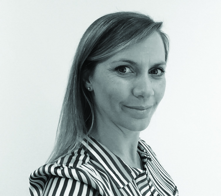 Smiling woman in striped shirt, looking at the camera.