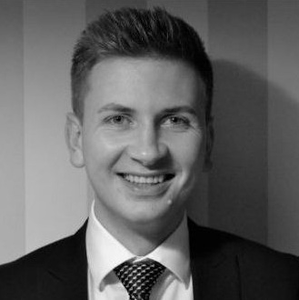 Black and white portrait of a smiling man in a suit