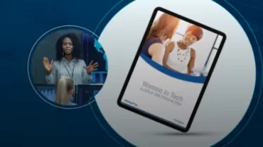 Woman speaking at a tech event with a tablet displaying 'Women in Tech' cover.
