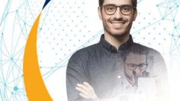 Smiling man with glasses, overlay of him looking into a microscope, geometric background.