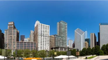 Panoramic view of Chicago skyline with modern skyscrapers under a clear blue sky.