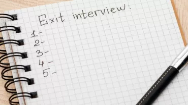 Notebook page titled 'Exit interview' with numbered list and pen.