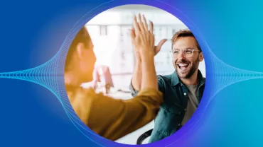 Two people giving a high-five with a blue background.