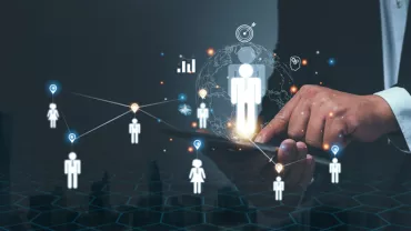 Hand interacting with a digital network of people icons