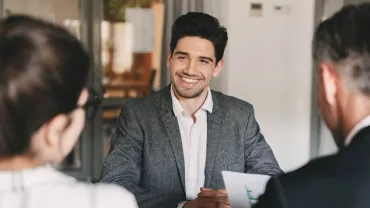 Two people interviewing for a job and are well presented 