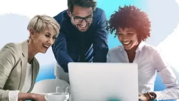 three people looking at computer screen 