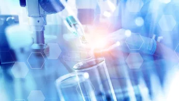 Scientist working with laboratory equipment and test tubes.