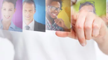 Person pointing at floating profile pictures of diverse individuals.