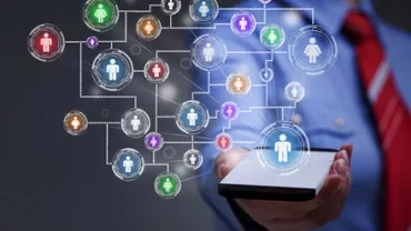 Person holding a smartphone displaying a network of connected icons symbolizing social connectivity.
