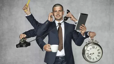 Man in suit multitasking with six arms holding phone, clock, cup, wrench, and tablet.