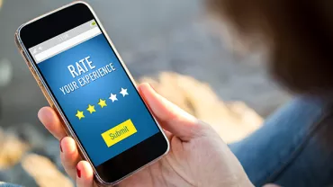 Person holding phone, rating experience on app with 3 stars.