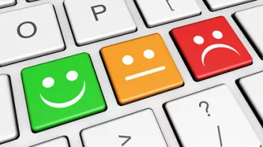 Keyboard with smiley, neutral, and sad face keys in green, orange, and red.