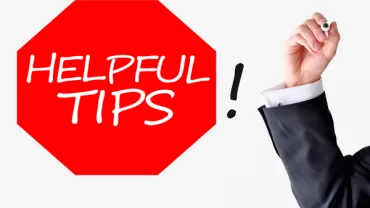 Red octagon with 'Helpful Tips' text; hand writing exclamation mark.