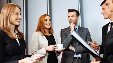 Group of professionals having a discussion in an office setting.