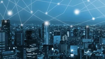 Digital network overlay on cityscape at night.