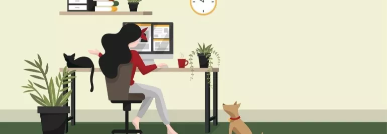 Woman working at a desk with plants, cat on desk, dog on floor.