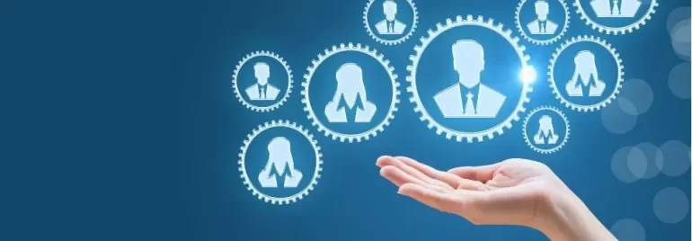 Hand reaching towards network of gear icons with silhouettes on blue background