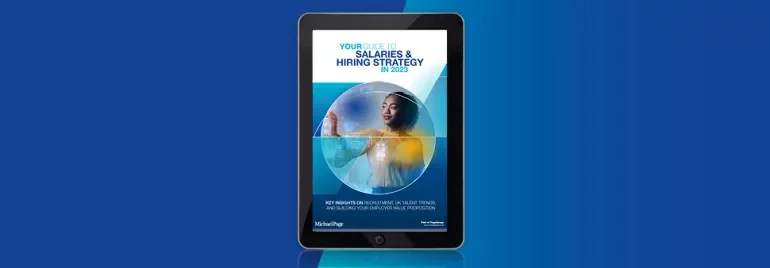 E-book on a tablet about salaries and hiring strategy for 2023.