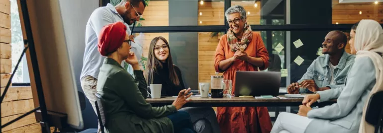 A diverse group of people holding a business meeting in a modern office.