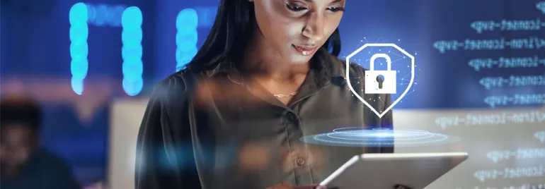 Woman using a tablet with a digital padlock icon overhead.