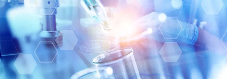 Scientist working with laboratory equipment and test tubes.