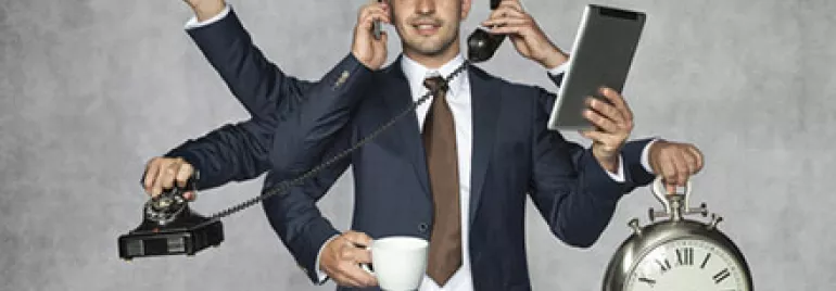 Man in suit multitasking with six arms holding phone, clock, cup, wrench, and tablet.