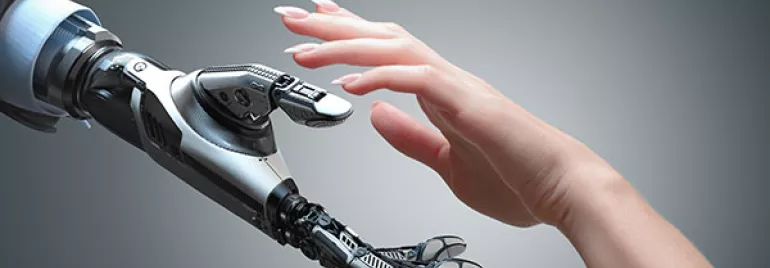 A robotic and a human hand reaching out to each other.