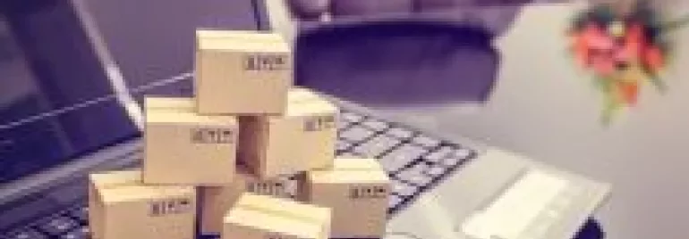 Small cardboard boxes on a laptop in an office setting.