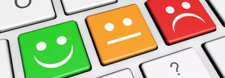 Keyboard with smiley, neutral, and sad face keys in green, orange, and red.