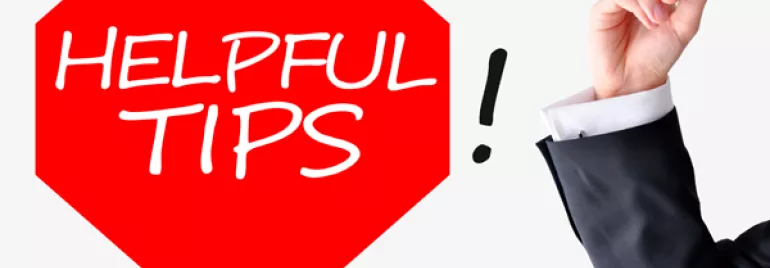 Red octagon with 'Helpful Tips' text; hand writing exclamation mark.