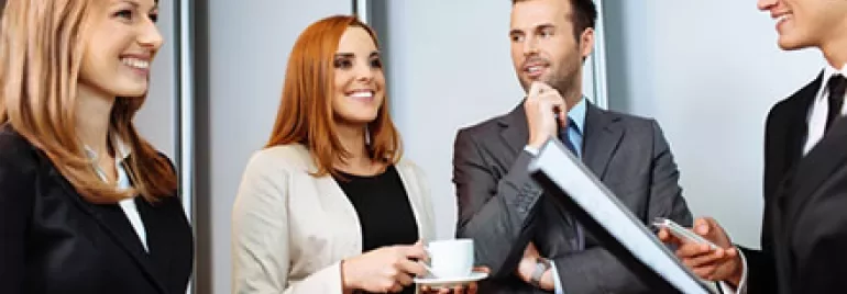 Group of professionals having a discussion in an office setting.