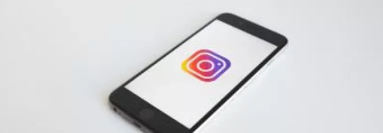Smartphone displaying Instagram logo on screen.