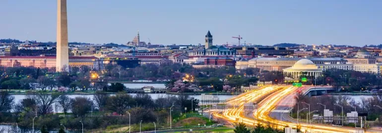 Washington D.C. skyline featuring the Washington Monument and Jefferson Memorial at dusk.