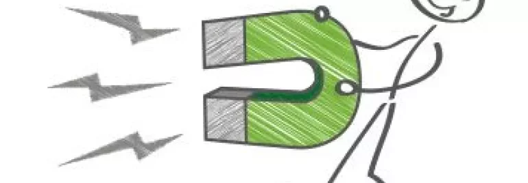 Stick figure holding a large green magnet attracting metal shavings.