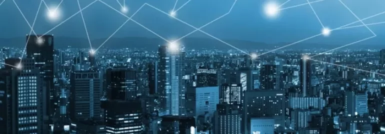 Digital network overlay on cityscape at night.
