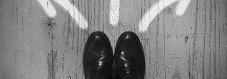 Top view of feet on concrete with three arrows pointing left, right, and forward.