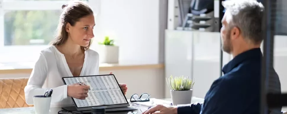 Laptop con hojas de cálculo y calculadora, indicando reportes y análisis financiero.