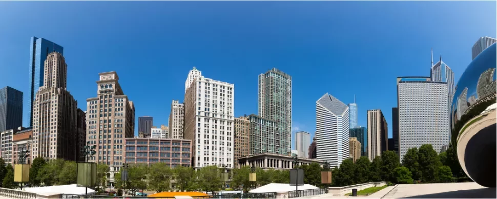 Panoramic view of Chicago skyline with modern skyscrapers under a clear blue sky.