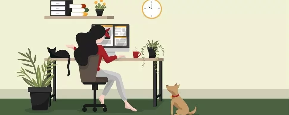 Woman working at a desk with plants, cat on desk, dog on floor.