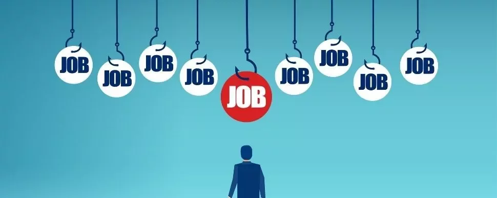 Silhouette of person looking at hanging 'job' signs with one highlighted in red.