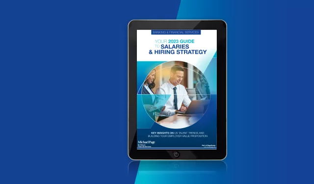 Tablet displaying '2023 Guide to Salaries & Hiring Strategy' cover with a business theme.
