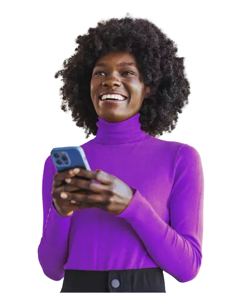 A person wearing a purple turtleneck holding a smartphone, standing against a plain background.