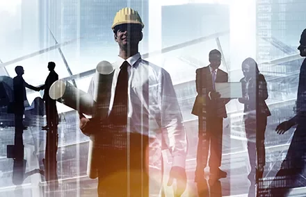 Business professionals and an engineer with blueprints in a cityscape background.