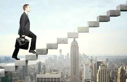 Businessman climbing floating stairs above city skyline.