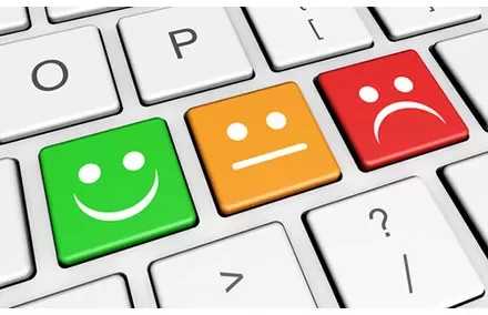 Keyboard with smiley, neutral, and sad face keys in green, orange, and red.