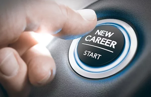 Hand pressing a button labeled 'new career start.'