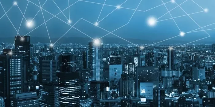 Digital network overlay on cityscape at night.